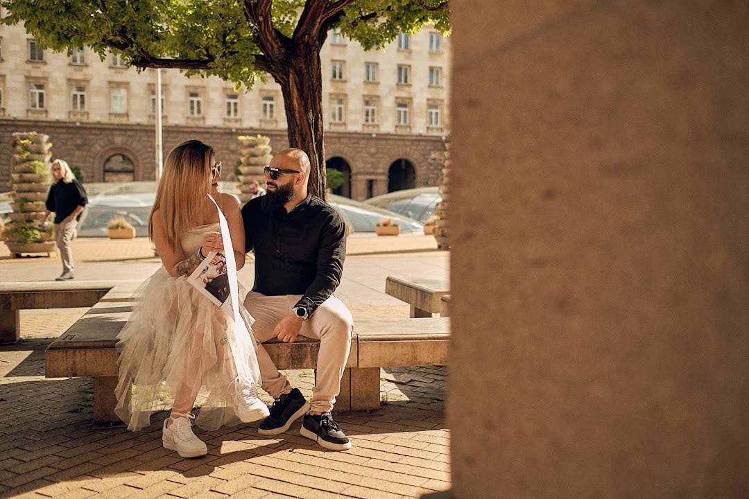 A couple sitting together in the city