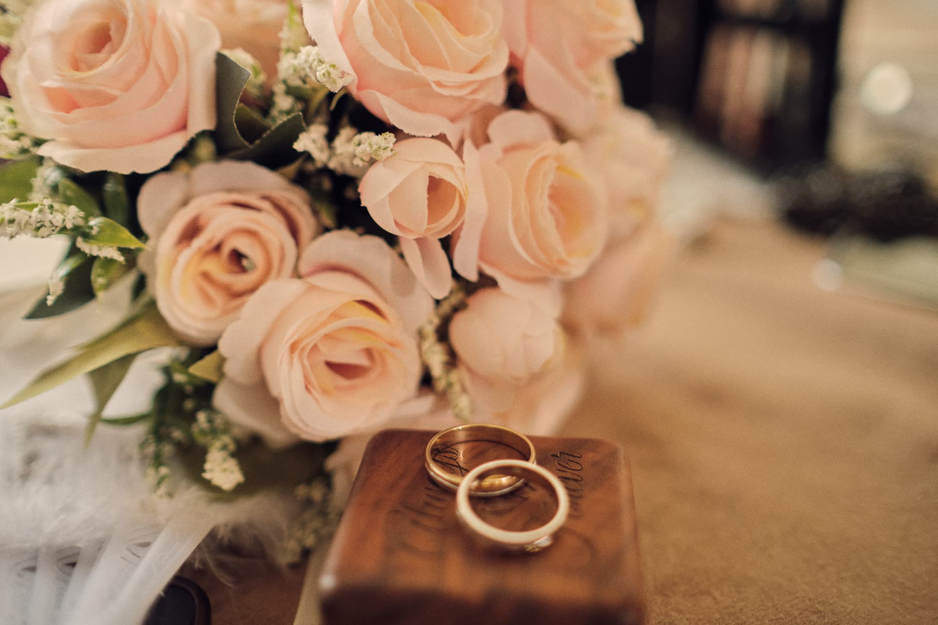 Wedding rings resting beside flowers