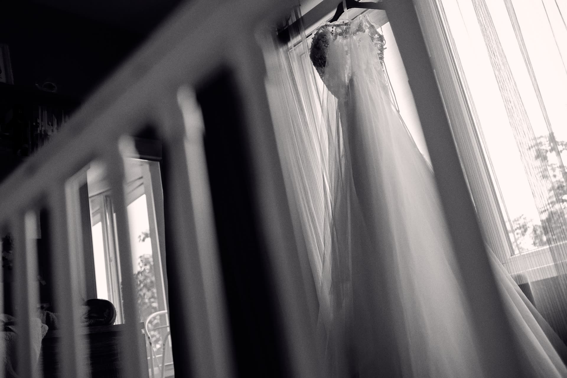 A wedding dress waiting beside the window