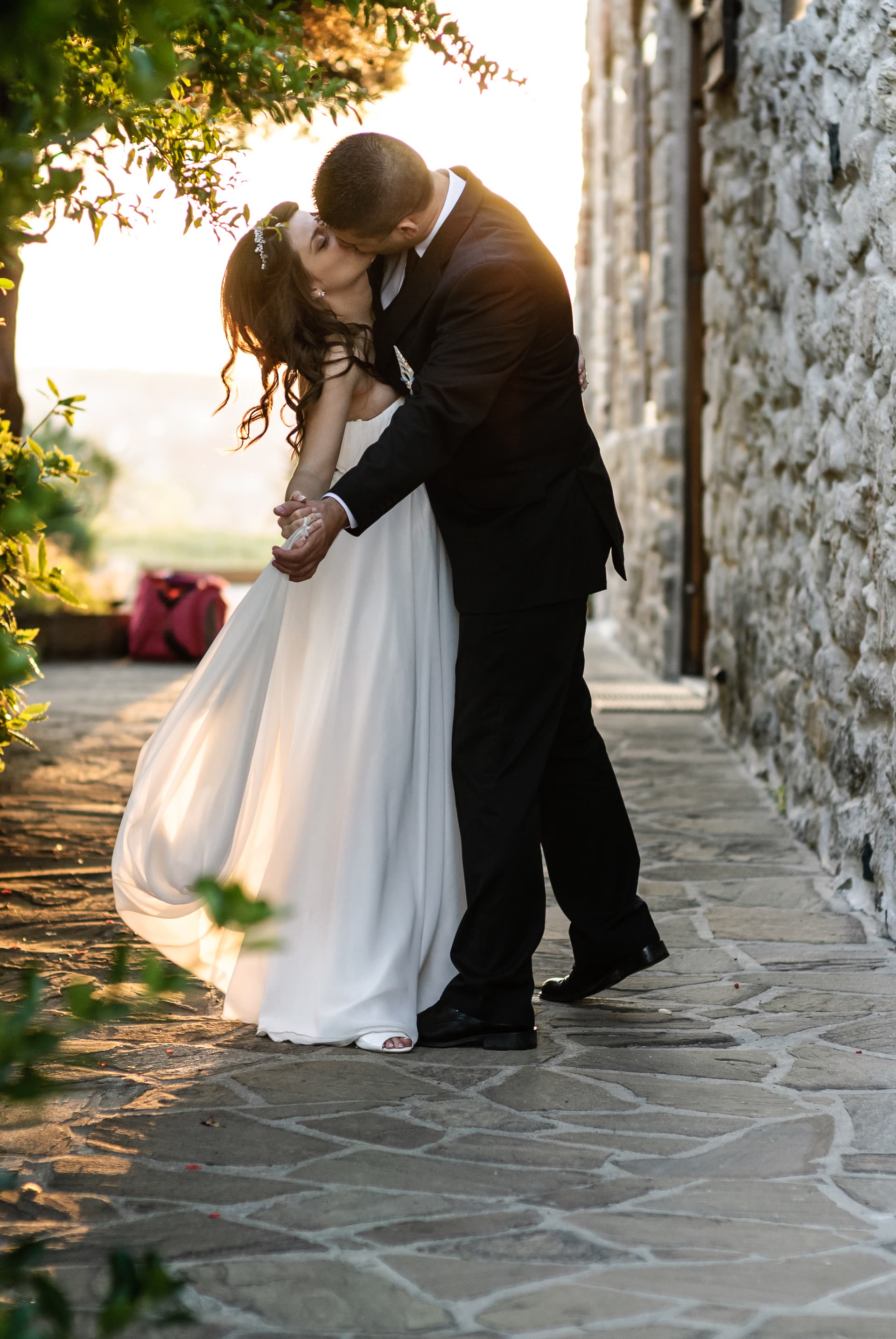 A newly married couple sharing an unguarded moment in the evening light