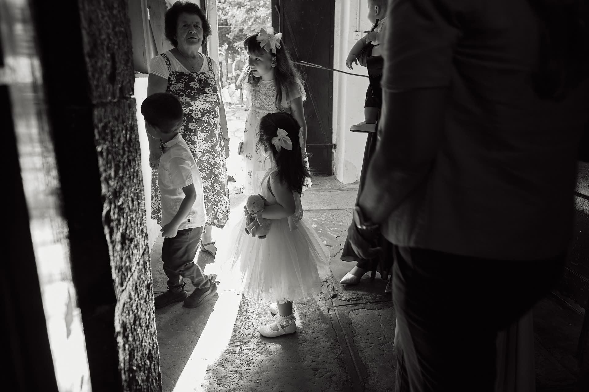 Children gathering at the doorway before a baptism