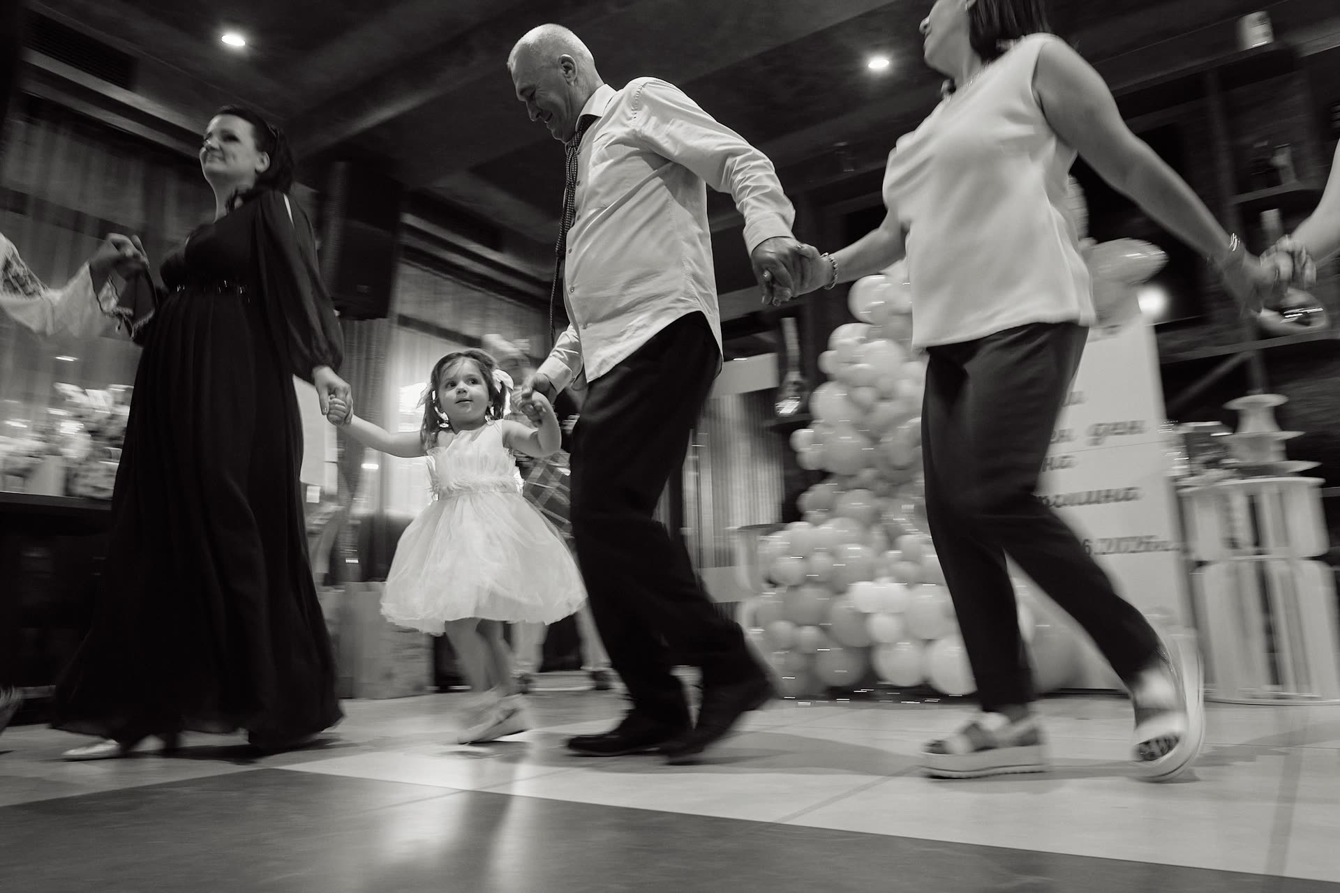 Guests moving through a dimly lit celebration
