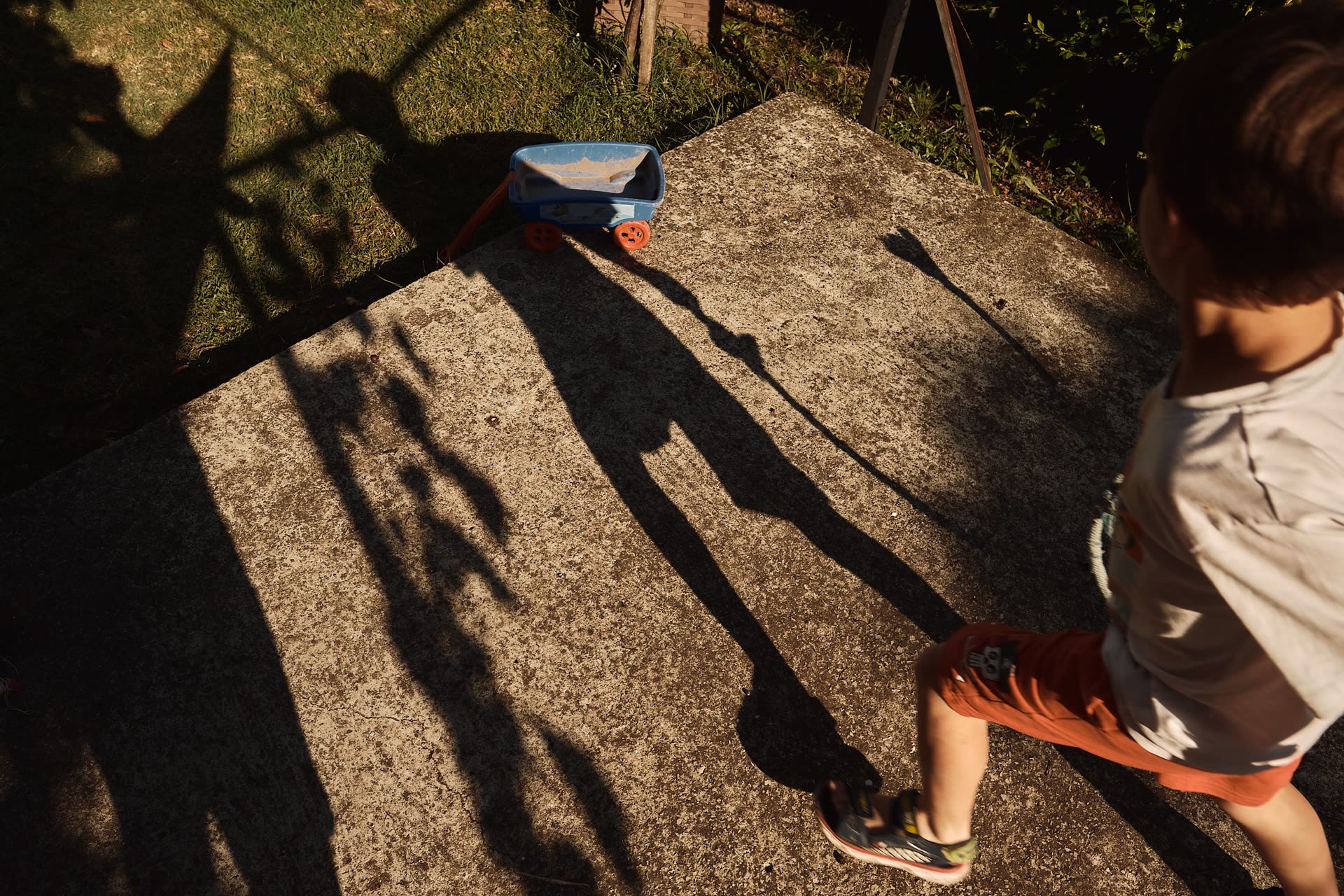 A child walking through sharp geometric shadows