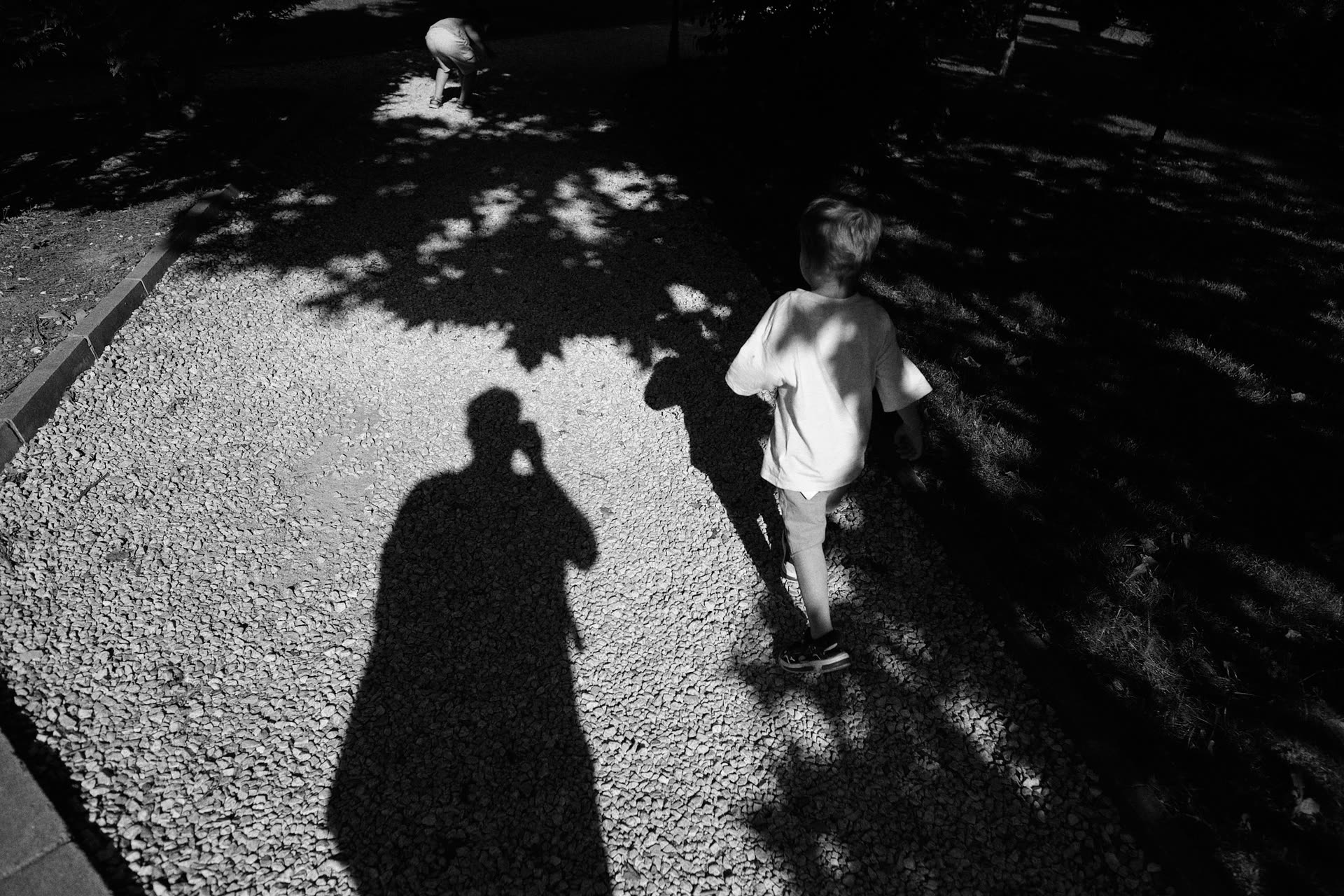 A child and photographer walking as two silhouettes